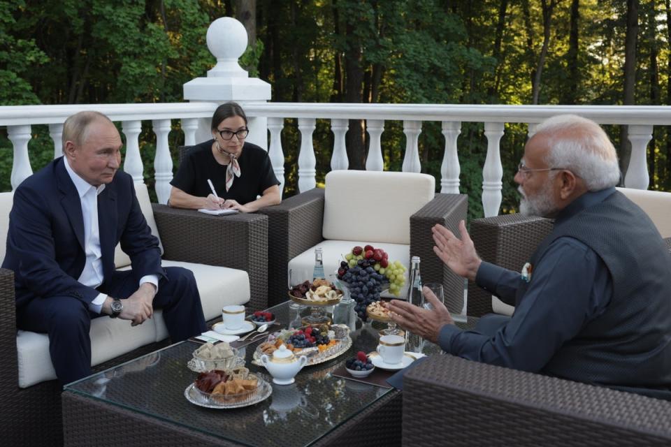 Russian President Vladimir Putin (L) and Indian Prime Minister Narendra Modi (R) talk during their official meeting in Novo-Ogaryovo residence outside Moscow (EPA)