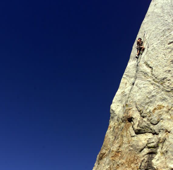 Climber works his way towards The edge on Tahquitz Rock in Idyllwild.