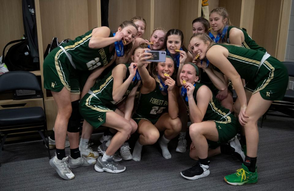 The Forest Park Rangers take a photo together following the IHSAA girls basketball Class 2A state championship at Gainbridge Fieldhouse in Indianapolis, Ind., Saturday afternoon, Feb. 26, 2022. The Forest Park Rangers girls basketball team earned a 52-44 win against the Frankton Eagles to earn their first state championship. 