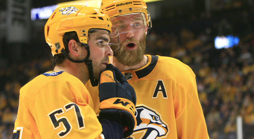 NASHVILLE, TN - DECEMBER 07: Nashville Predators defenseman Mattias Ekholm (14) talks with defenseman Dante Fabbro (57) during the NHL game between the Nashville Predators and New Jersey Devils, held on December 7, 2019, at Bridgestone Arena in Nashville, Tennessee. (Photo by Danny Murphy/Icon Sportswire via Getty Images)