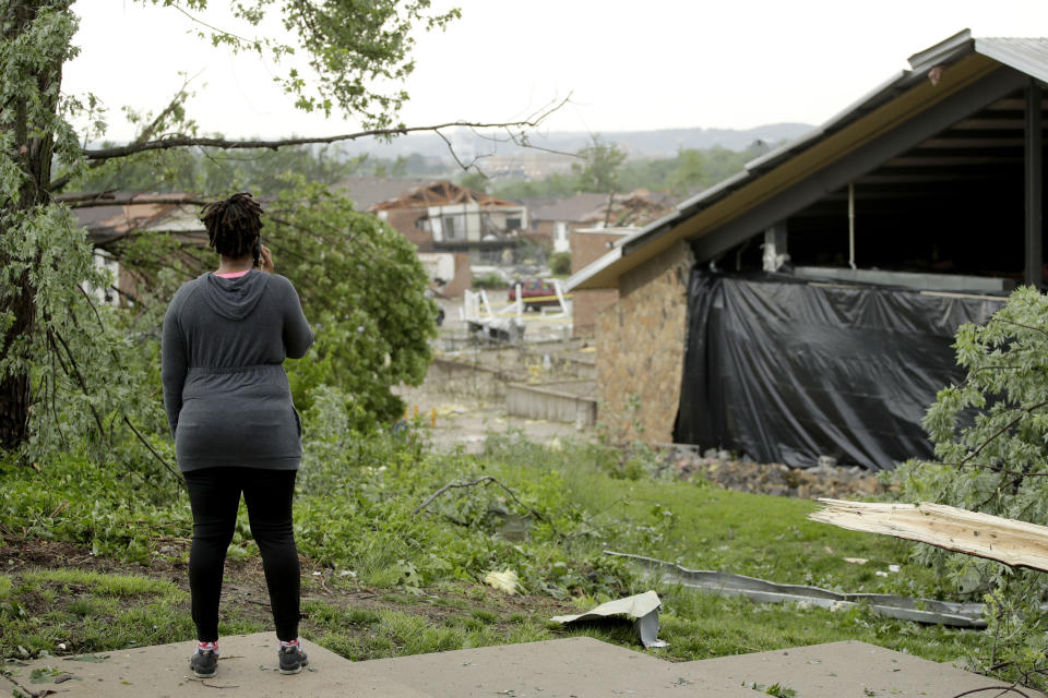 A woman surveys damage on May 23, 2019 after a tornado tore though Jefferson City, Mo. late May 22, 2019. (Photo: Charlie Riedel/AP)