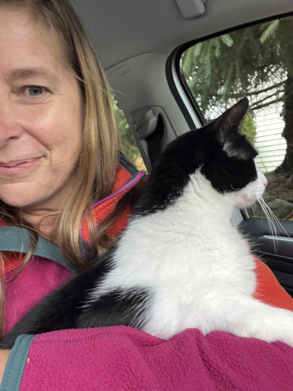 In this photo provided by Elizabeth Wilkins, she is shown with her cat Leo on Aug. 3, 2023, in Juneau, Alaska. Wilkins and her partner Tom Schwartz, were reunited with Leo 26 days after their home collapsed into the swollen Mendenhall River Aug. 5, 2023, in Juneau, Alaska. (Elizabeth Wilkins via AP)