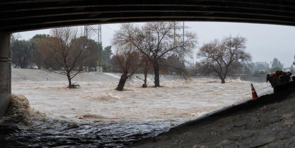 Floodwaters rush through an underpass in Los Angeles, California on Monday (AFP via Getty Images)