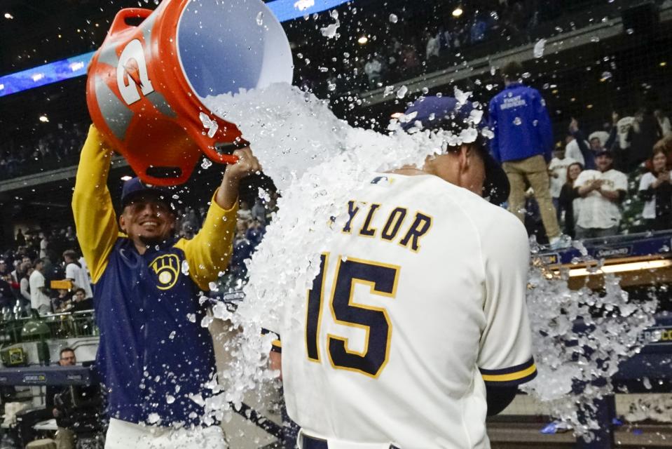 Milwaukee Brewers' Willy Adames douces Tyrone Taylor after a baseball game against the St. Louis Cardinals Wednesday, Sept. 27, 2023, in Milwaukee. The Brewers won 3-2. (AP Photo/Morry Gash)