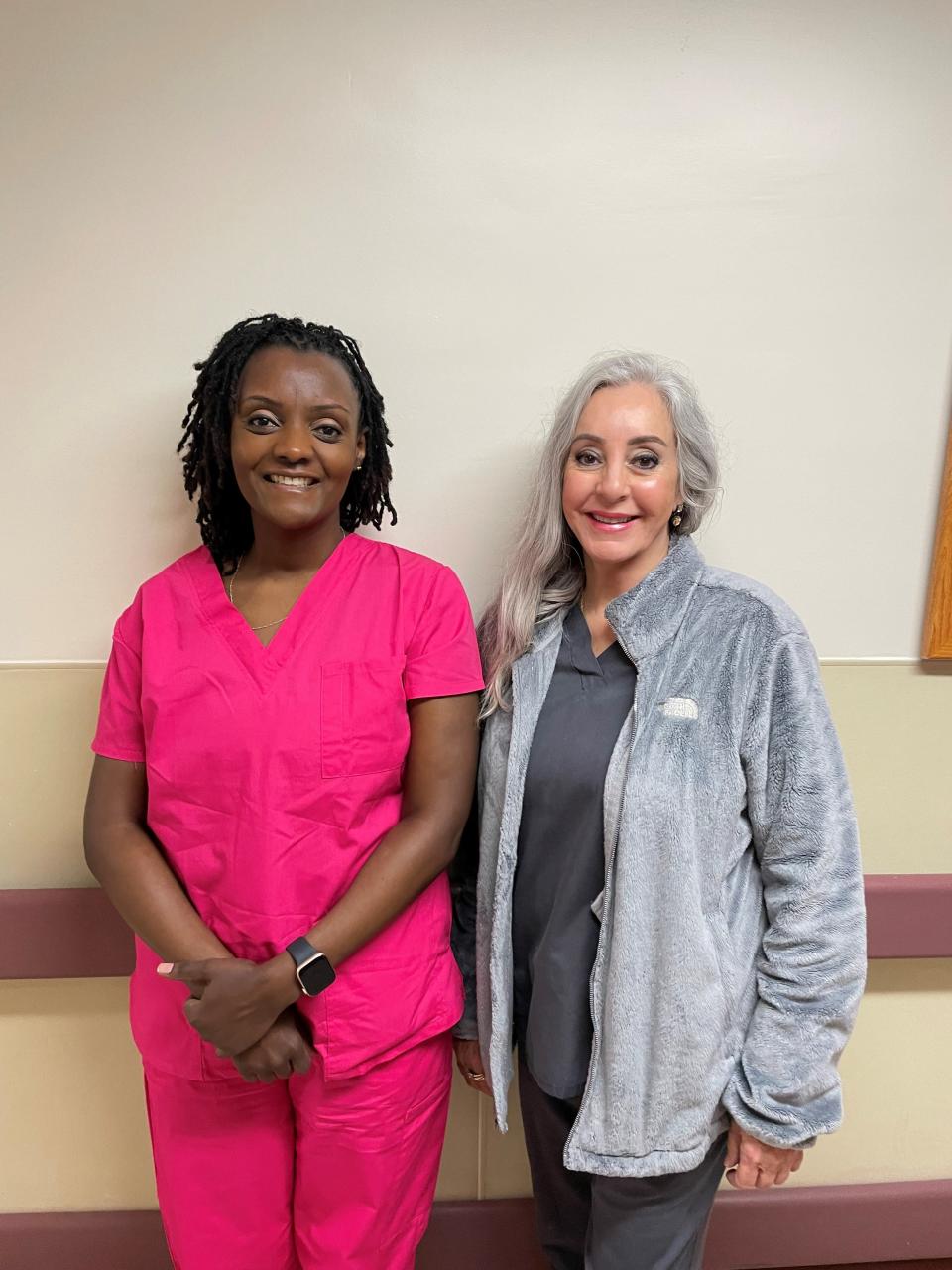 Irene Njeru, left, and Julie Wheat work the same shift at the same hospital as registered nurses, and share the same oncologist. They are each others’ biggest supporters in their respective battles against breast cancer.