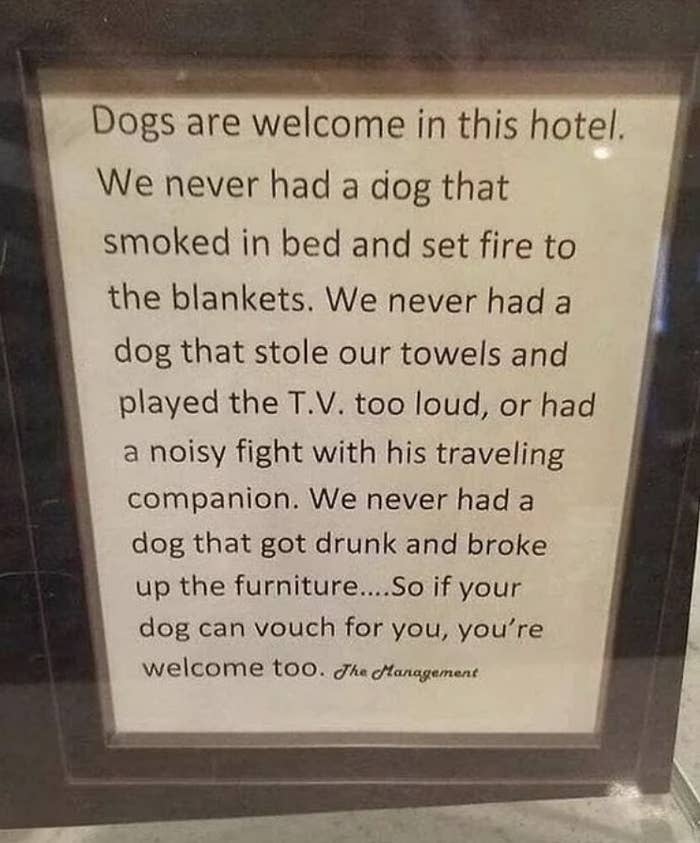 Hotel sign stating dogs are welcome because they don't cause disturbances. Ends with 