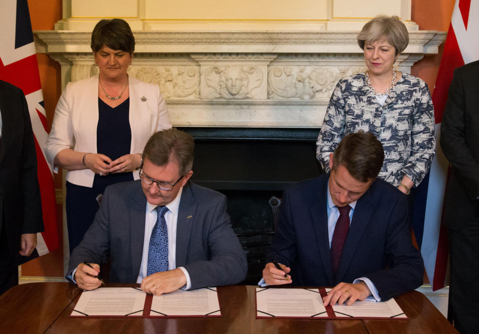 File photo dated 26/06/17 of Prime Minister Theresa May standing with DUP leader Arlene Foster (left), as DUP MP Sir Jeffrey Donaldson (second right) and Parliamentary Secretary to the Treasury, and Chief Whip, Gavin Williamson, sign paperwork inside 10 Downing Street, London, after the DUP agreed a deal to support the minority Conservative government. The Prime Minister is expected to announce details later today of her timetable for leaving Downing Street.