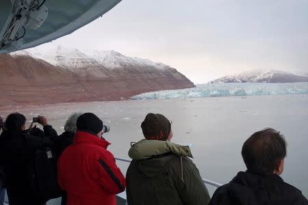 Visitors take pictures of a glacier in the Kongsfjorden fjord from onboard the Polarsyssel, the ship of the Governor of Svalbard, in the Arctic archipelago of Svalbard, Norway, September 20, 2016. Picture taken September 20, 2016. REUTERS/Gwladys Fouche
