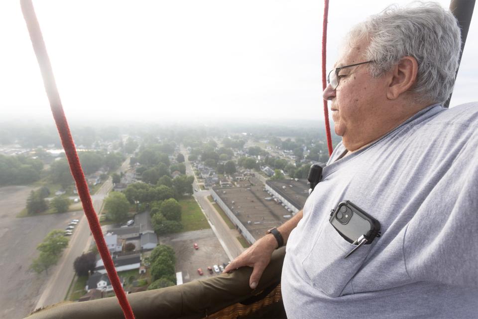 Diamond Girl balloon pilot Ken Kus of Chagrin Falls looks out over North Canton on Friday morning during the media/sponsor flight as part of the 2023 Balloon Classic.