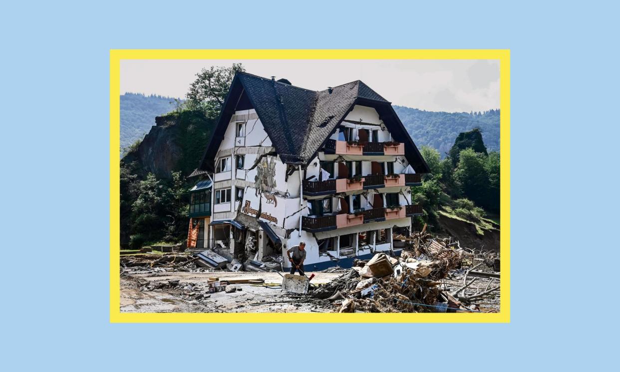 <span>A worker clears debris outside a guesthouse near Altenahr in July 2021.</span><span>Composite: CHRISTOF STACHE /AFP via Getty Images</span>