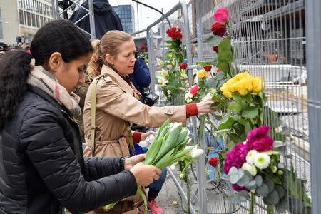 STOCKHOLM 2017-04-08 People lay flowers near the crime scene, near the Ahlens department store, in central Stockholm the morning after a hijacked beer truck plowed into pedestrians on Drottninggatan and crashed into Ahlens department store on Friday, killing four people, injuring 15 others. TT News Agency/Anders Wiklund/via REUTERS