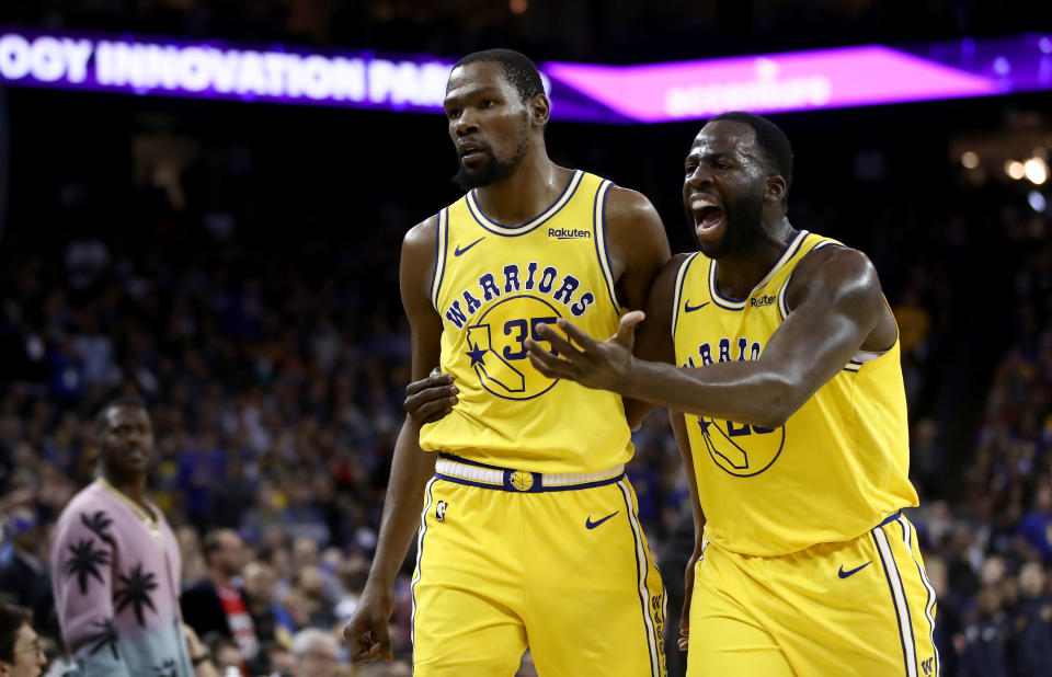 OAKLAND, CALIFORNIA - APRIL 02:  Kevin Durant #35 of the Golden State Warriors is escorted off the court by Draymond Green #23 after Durant was ejected from the game for complaining about a call during their game against the Denver Nuggets at ORACLE Arena on April 02, 2019 in Oakland, California.  NOTE TO USER: User expressly acknowledges and agrees that, by downloading and or using this photograph, User is consenting to the terms and conditions of the Getty Images License Agreement. (Photo by Ezra Shaw/Getty Images)