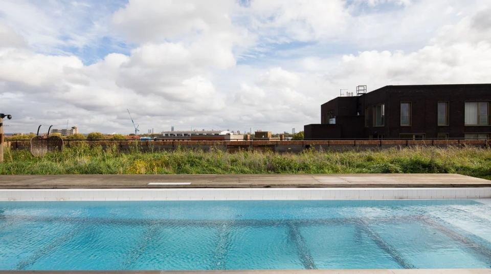 <p>Ok, so it's not a cottage with a pool per se but this luxury flat in East London is worth a mention for its rooftop pool. The communal rooftop is the cherry on top of this seriously hip pad. Located in London Fields and filled with colour, a mix of textures from velvet to wood and specially commissioned graffiti chairs, this place screams cool. </p><p><strong>Sleeps:</strong> 2</p><p><strong>Pets: </strong>Yes</p><p><strong>Bring:</strong> Your most stylish sunnies to soak up the rays from a height.</p><p><strong>Price: </strong>£722 for 2 nights</p><p><strong>Available from: </strong><a href="https://go.redirectingat.com?id=127X1599956&url=https%3A%2F%2Fwww.plumguide.com%2Fhomes%2F22280%2Fthe-graffiti-artist&sref=https%3A%2F%2Fwww.womenshealthmag.com%2Fuk%2Ffitness%2Ffitness-holidays%2Fg33559308%2Fcottages-with-pools%2F" rel="nofollow noopener" target="_blank" data-ylk="slk:Plum Guide;elm:context_link;itc:0;sec:content-canvas" class="link ">Plum Guide</a></p>