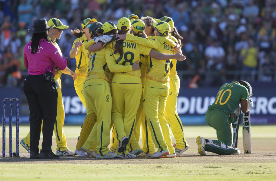 Australia players celebrate winning against South Africa in the Women's T20 World Cup semi final cricket match between South Africa and Australia, in Cape Town, South Africa, Sunday Feb. 26, 2023. (AP Photo/Halden Krog)