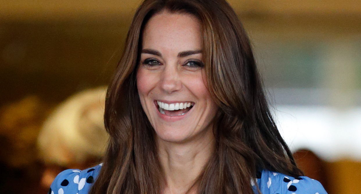 kate middleton with long brown hair wearing blue floral dress 