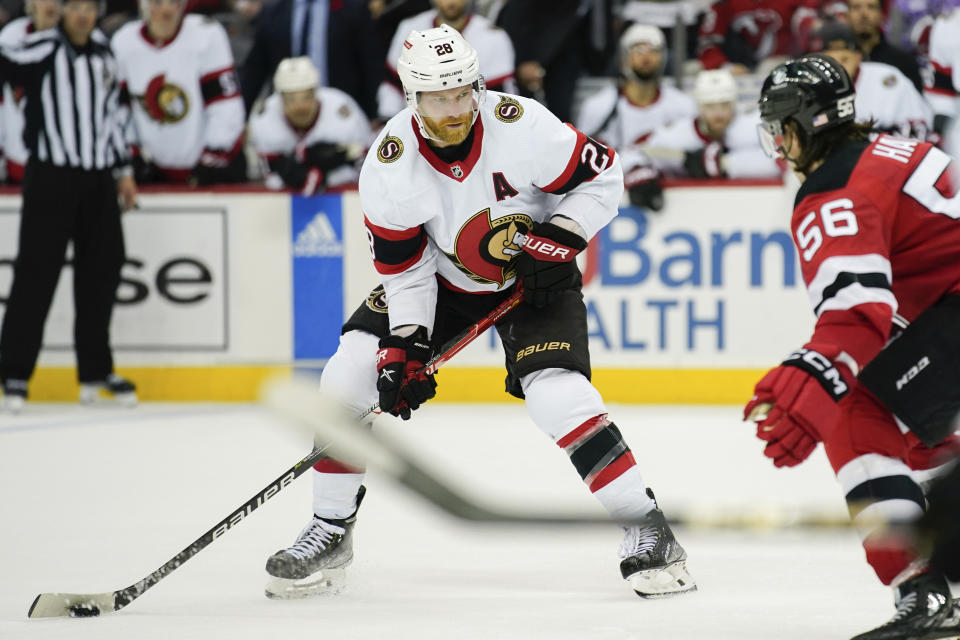 Ottawa Senators right wing Claude Giroux (28) works with the puck next to New Jersey Devils left wing Erik Haula (56) during the overtime of an NHL hockey game, Thursday, Nov. 10, 2022, in Newark, N.J. The Devils won 4-3. (AP Photo/Julia Nikhinson)