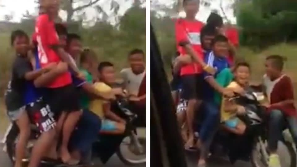 Nine people are crammed onto this motorbike in Thailand, including eight children and one adult.