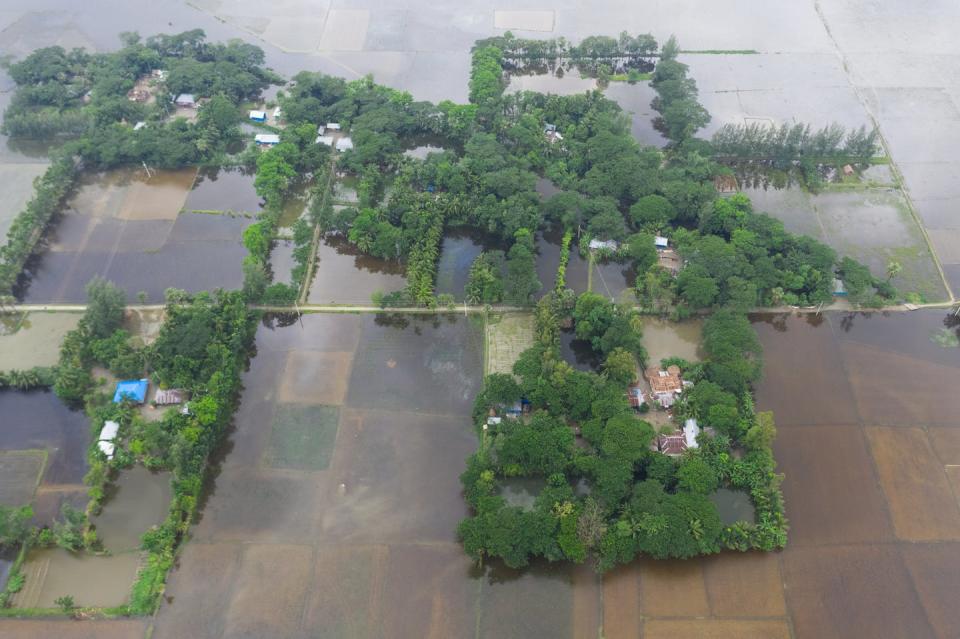 <span class="caption">Floodwaters rise in a village in southern Bangladesh in July 2019.</span> <span class="attribution"><a class="link " href="https://www.gettyimages.com/detail/news-photo/due-to-flood-villages-in-the-southern-part-of-bangladesh-news-photo/1155805279?adppopup=true" rel="nofollow noopener" target="_blank" data-ylk="slk:Mohammad Saiful Islam/Getty Images;elm:context_link;itc:0;sec:content-canvas">Mohammad Saiful Islam/Getty Images</a></span>