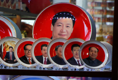 FILE PHOTO: Souvenir plates featuring portraits of former and current Chinese leaders including President Xi Jinping and the late Chinese Chairman Mao Zedong are displayed for sale at a shop next to Tiananmen Square in Beijing, Chinam March 1, 2018. REUTERS/Jason Lee