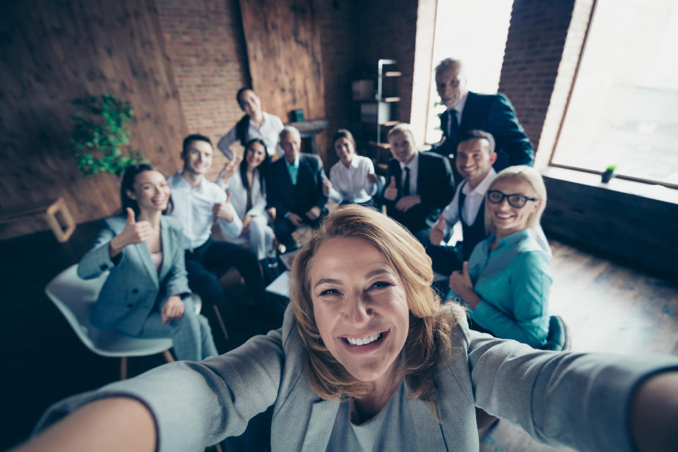 Self-portrait above high angle view of nice stylish cheerful glad positive director company staff showing thumbsup yes goal achievement recommend modern industrial loft interior work place open space.