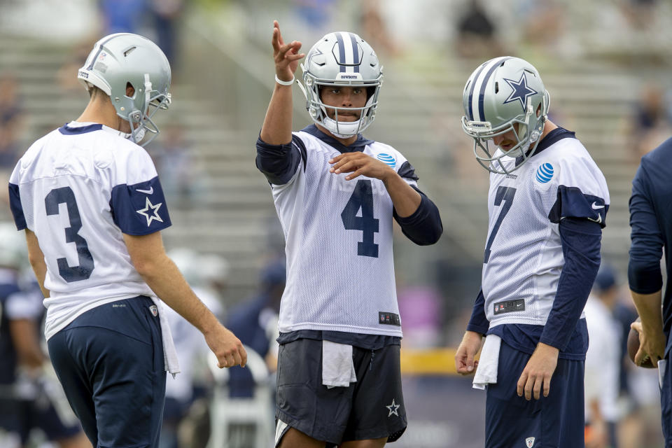 Dallas Cowboys quarterbacks Mike White (3), Dak Prescott (4) and Cooper Rush (7) talk during the NFL football team's training camp Thursday, July 26, 2018, in Oxnard, Calif. (AP Photo/Gus Ruelas)