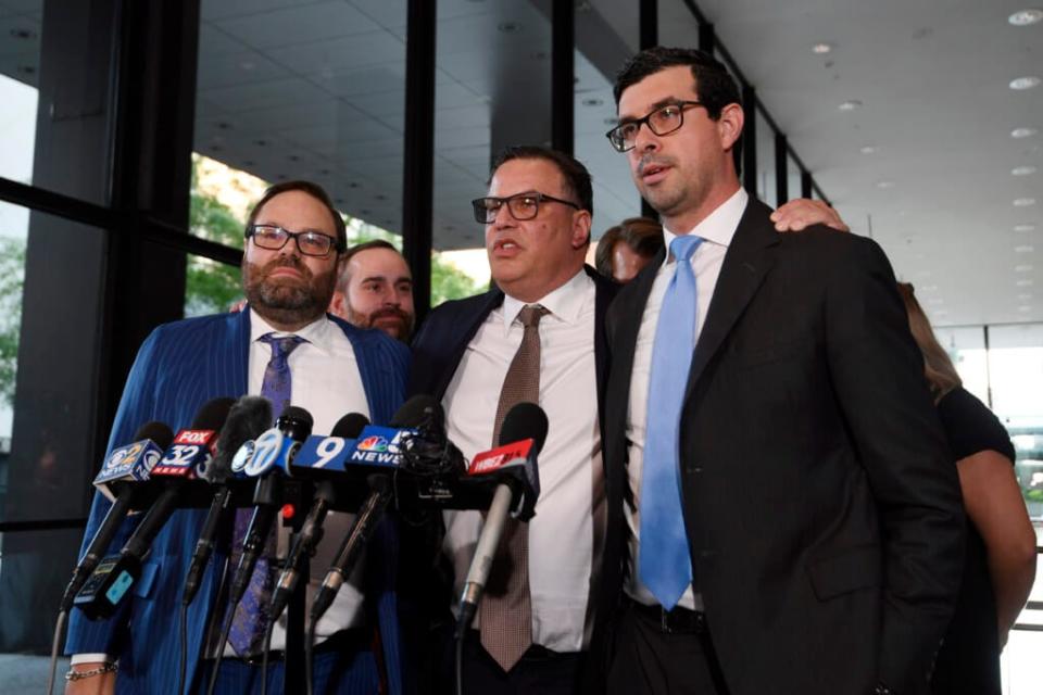 Derrel McDavid, center, stands with his attorney’s Vadim Glozman, right, and Beau Brindley, left, at the Dirksen Federal Courthouse in Chicago after verdicts were reached in R. Kelly’s trial, Wednesday, Sept. 14, 2022, in Chicago. Jurors acquitted McDavid, a longtime Kelly business manager, who was accused of conspiring with Kelly to rig the 2008 trial. (AP Photo/Matt Marton)