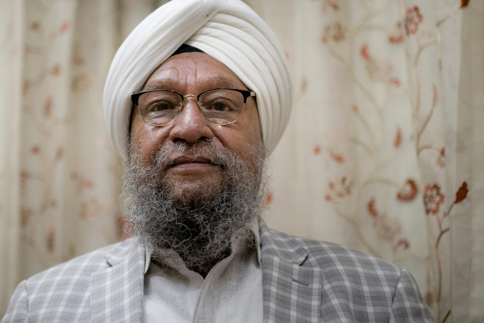 Paramjit Singh Bedi, co-chair of Guru Nanak Darbar of Long Island, a Sikh gurudwara, stands in the special rest room where the Guru Granth Sahib, the Sikh holy book, resides in the evening hours, Wednesday, Aug. 24, 2022, in Hicksville, N.Y. An Afghan Sikh family of 13 has found refuge in the diaspora community on Long Island where the Sikh community is helping family members obtain work permits, housing, healthcare and find schools for the children. (AP Photo/John Minchillo)