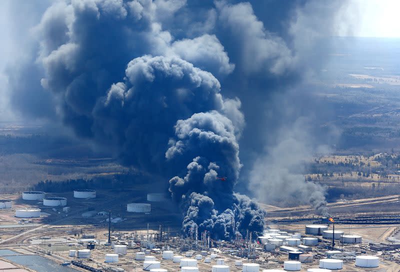 FILE PHOTO: Dark smoke rises from Husky Energy oil refinery following an explosion in Superior Wisconsin