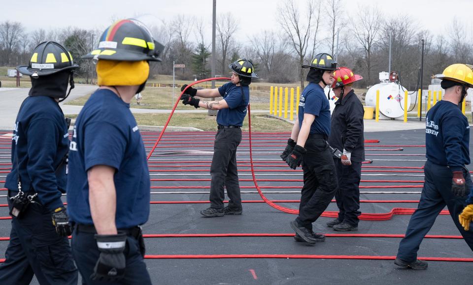 Matthew Smith holds a firehose during training at the Division of State Fire Marshal's Ohio Fire Academy.