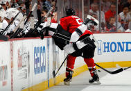 NEWARK, NJ - JUNE 09: Mike Richards #10 of the Los Angeles Kings falls into the bench as Zach Parise #9 of the New Jersey Devils makes contact during Game Five of the 2012 NHL Stanley Cup Final at the Prudential Center on June 9, 2012 in Newark, New Jersey. (Photo by Bruce Bennett/Getty Images)