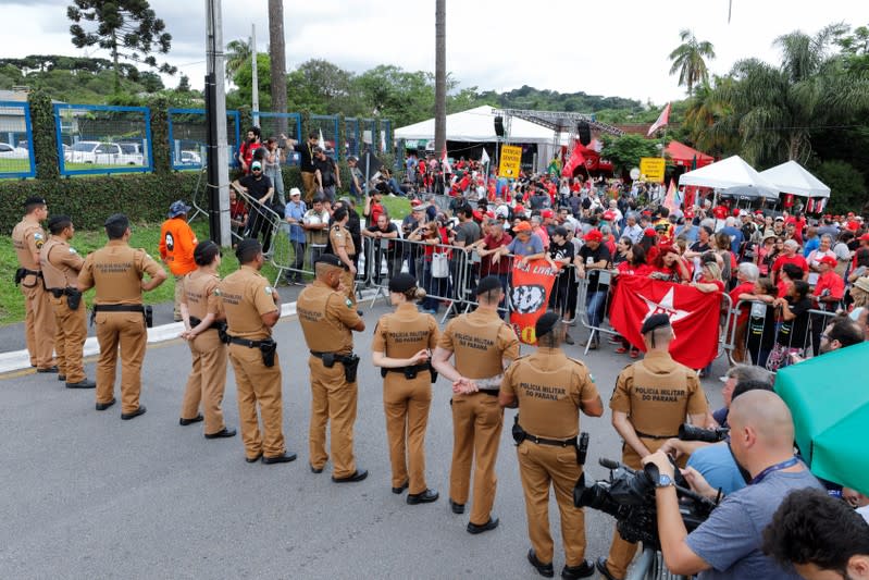 Members of the security forces stand guard and block a road in front of the Federal Police headquarters where Lula is serving a prison sentence, in Curitiba