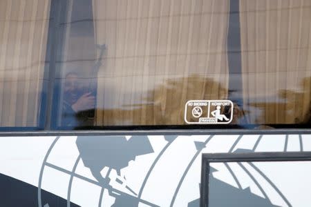 A rebel woman fighter reacts as she holds her weapon on a bus, as rebel fighters and their families evacuate from the besieged Waer district, after an agreement was reached between rebels and Syria's army, in Homs, Syria May 20, 2017. REUTERS/Omar Sanadiki