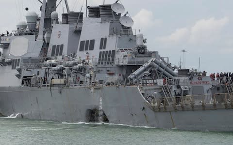 The latest accident happened before dawn Monday in busy shipping lanes around the Strait of Singapore, with water flooding into the vessel after the huge hole was torn in the hull. - Credit: AP