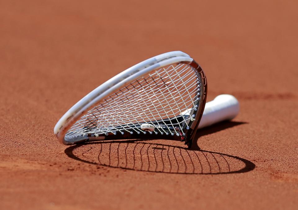 The broken racket of Novak Djokovic of Serbia is seen on the court after he smashed it during his men's semi-final match against Ernests Gulbis of Latvia at the French Open tennis tournament at the Roland Garros stadium in Paris June 6, 2014. REUTERS/Vincent Kessler (FRANCE - Tags: SPORT TENNIS TPX IMAGES OF THE DAY)