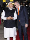 Indian Prime Minister Narendra Modi, left, and Australian Prime Minster Anthony Albanese arrive for an Indian community event in Sydney, Tuesday, May 23, 2023. Modi has arrived in Sydney for his second Australian visit as India's prime minister and told local media he wants closer bilateral defense and security ties as China's influence in the Indo-Pacific region grows. (Wolter Peeters/Pool Photo via AP)