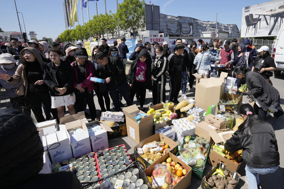Members of Poland's Vietnamese community collect food donations, in Warsaw, Poland, Wednesday, May 15, 2024. A weekend fire in a shopping center in Warsaw dealt tragedy to many members of Poland's Vietnamese community. People lost entire livelihoods and say they don't know how they will manage to make a living. (AP Photo/Czarek Sokolowski)