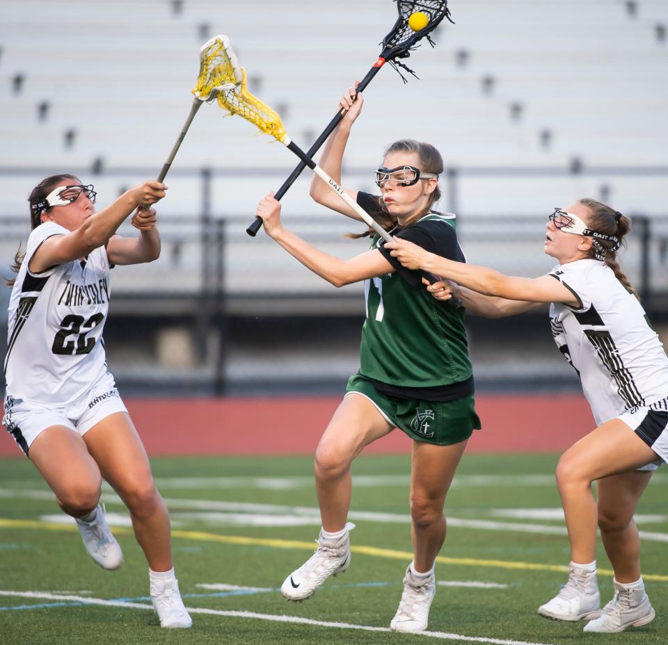 York Catholic's Katie Bullen maneuvers between a pair of Twin Valley players during the PIAA District 3 Class 2A girls' lacrosse championship at Landis Field on Wednesday, May 25, 2022, in Harrisburg. 