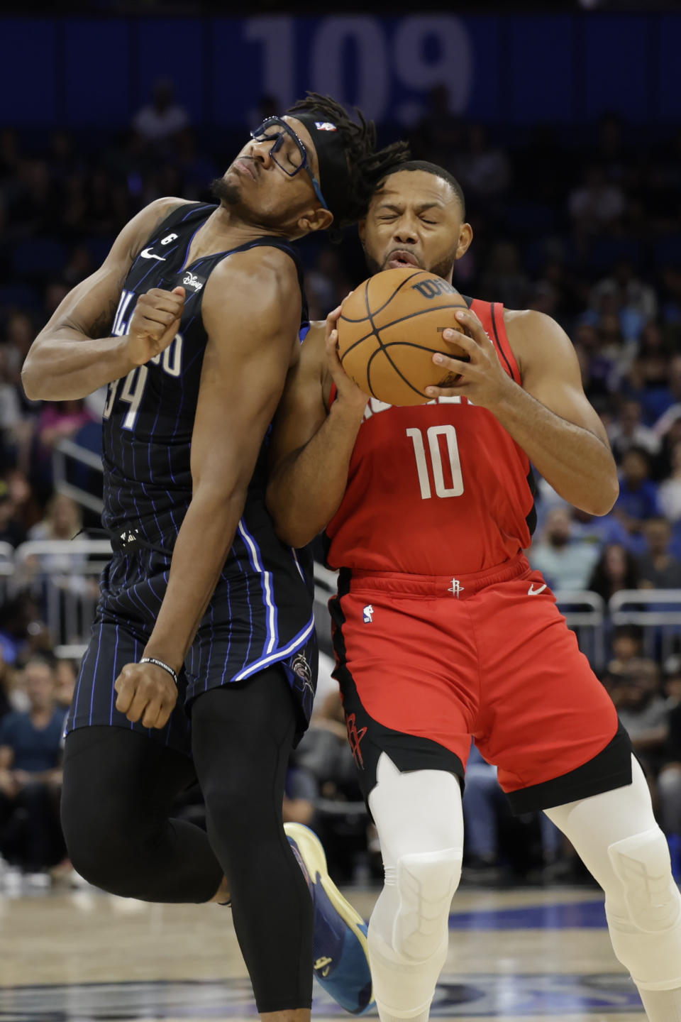 Houston Rockets guard Eric Gordon (10) bumps Orlando Magic center Wendell Carter Jr. (34) during the first half of an NBA basketball game, Monday, Nov. 7, 2022, in Orlando, Fla. (AP Photo/Kevin Kolczynski)