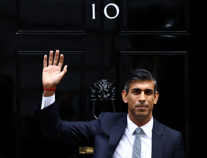 Nuevo primer ministro británico, Rishi Sunak, saluda al entrar en el número 10 de Downing Street, en Londres