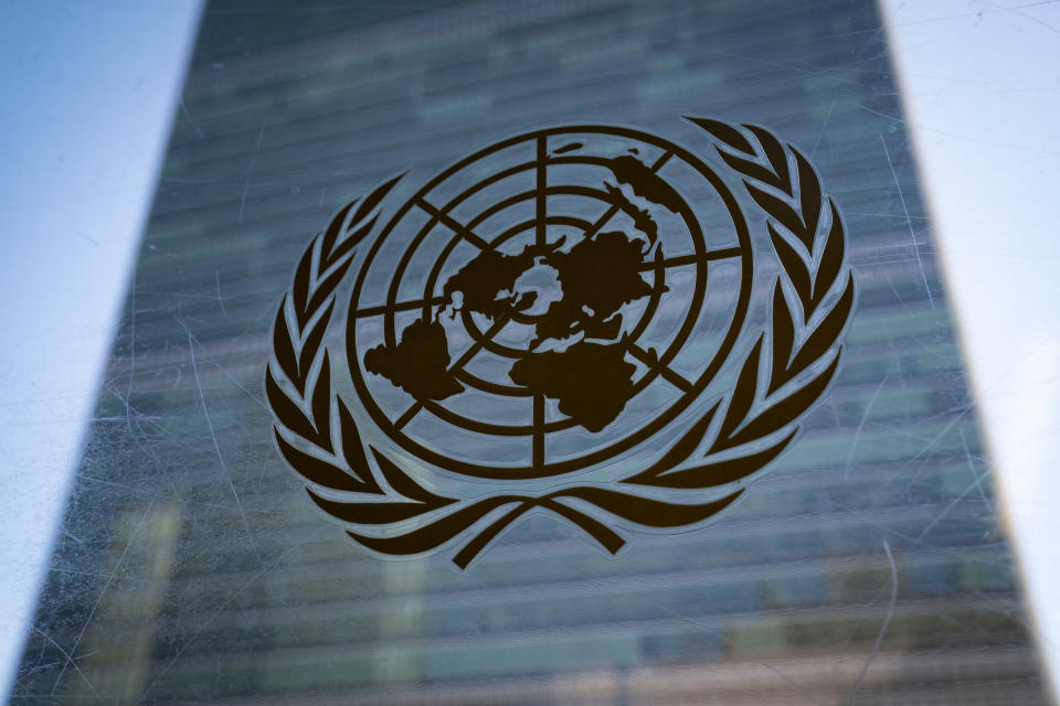 The symbol of the United Nations is displayed outside the Secretariat Building during an emergency meeting of the UN General Assembly, Monday, Feb. 28, 2022, at United Nations Headquarters. The U.N.'s two major bodies, the 193-nation General Assembly and the more powerful 15-member Security Council, are holding separate meetings Monday on Russia's invasion of Ukraine. (AP Photo/John Minchillo)