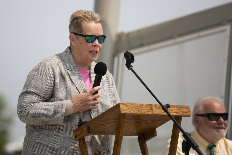 Grand Haven mayor, Catherine McNally, gives opening remarks at the Lynne Sherwood Waterfront Stadium in Grand Haven, Mich., on Saturday, June 10, 2023. The festival — which organizers had hoped would attract at least 500 attendees — drew thousands of people from all over who came to experience the first-time event's drag show, dance party and vendor-filled streets. (AP Photo/Kristen Norman)