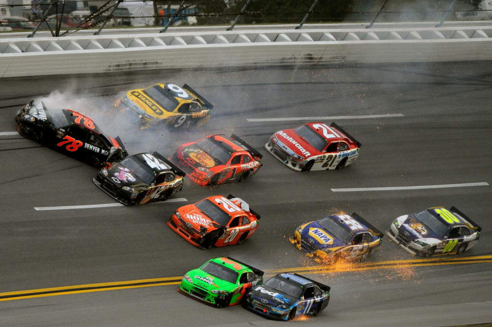 TALLADEGA, AL - OCTOBER 23: Regan Smith, driver of the #78 Furniture Row Companies Chevrolet, crashes as Mark Martin, driver of the #5 GoDaddy.com Chevrolet, and Denny Hamlin, driver of the #11 FedEx Office Toyota, make contact during the NASCAR Sprint Cup Series Good Sam Club 500 at Talladega Superspeedway on October 23, 2011 in Talladega, Alabama. (Photo by Jared C. Tilton/Getty Images for NASCAR)