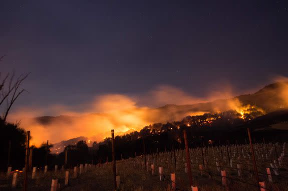 Fire glows on a hillside in Napa, California on October 9, 2017, as multiple wind-driven fires continue to whip through the region.