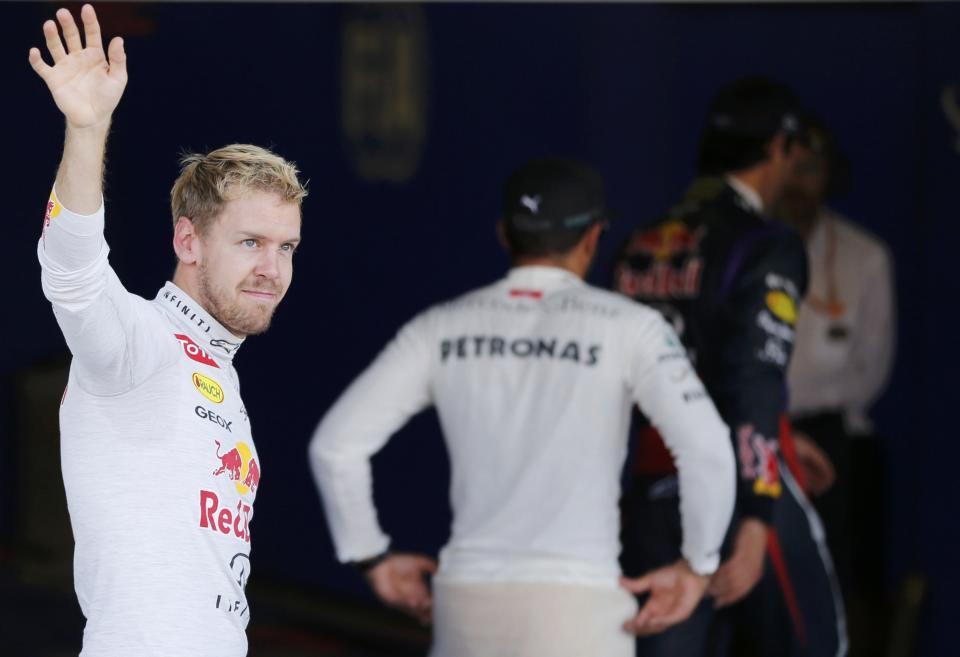 Red Bull Formula One driver Sebastian Vettel of Germany wave after the qualifying session of the Japanese F1 Grand Prix at the Suzuka circuit October 12, 2013. REUTERS/Issei Kato (JAPAN - Tags: SPORT MOTORSPORT F1)