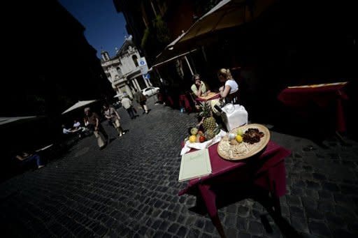 Tourists eat at a restaurant in Rome on May 4. Italians voted in local elections Sunday seen as a test of the country's political mood nearly six months after Prime Minister Mario Monti's government took over and imposed a biting austerity programme