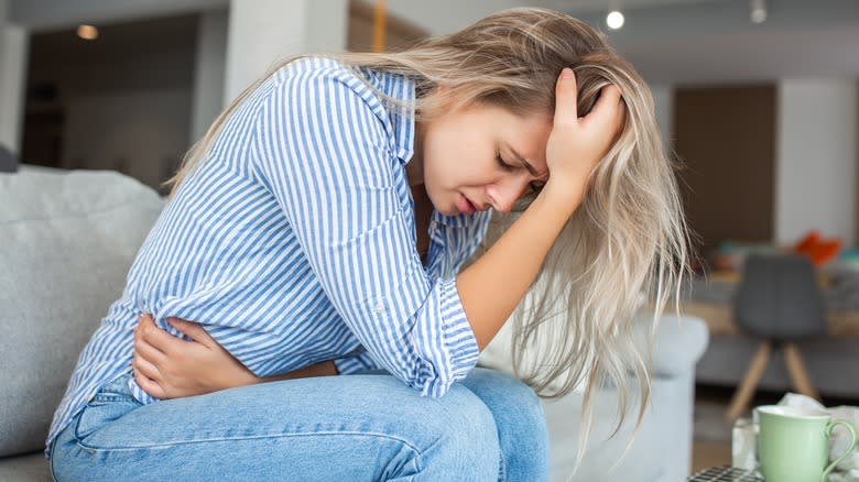 woman holding stomach