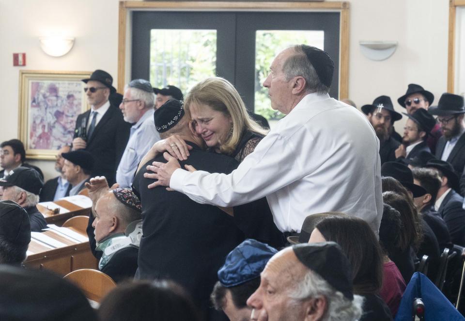 4/29/19 11:43:06 AM -- Poway, CA, U.S.A  -- Hundreds of people came for funeral service to pay respect to Lori Kaye, who died to save rabbis life at Chabad of Poway synagogue. Rabbi Yisroel Goldstein, leader of Congregation Chabad, gives hugs to family and friends.  Photo by Nick Oza, Gannett

 

 ORG XMIT:  NO 137984 Chabad follow 4/28/2019 (Via OlyDrop)