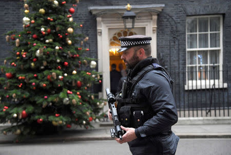 An armed police officer walks past 10 Downing Street, London, Britain, December 6, 2017. REUTERS/Toby Melville