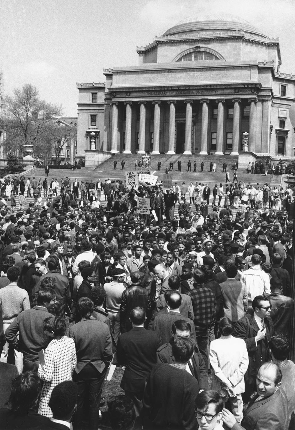 FILE - Demonstrators and students protesting the war in Vietnam are seen at the plaza in front of Columbia University's Low Memorial Library in New York, April 27, 1968. Policemen line the steps of the library, one of five buildings that protesters continue to occupy during the sit-in. (AP Photo/John Duricka, File)