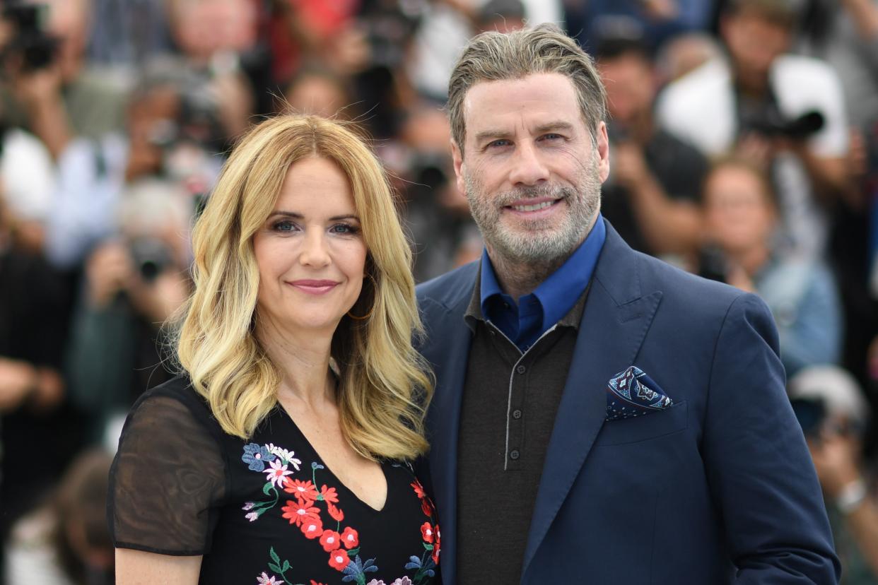US actor John Travolta (R) and his wife US actress Kelly Preston pose on May 15, 2018 during a photocall for the film 